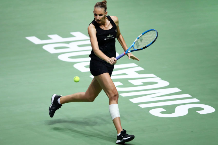 KAROLINA PLISKOVA of the Czech Republic plays a backhand in her singles match against Petra Kvitova of the Czech Republic during the BNP Paribas WTA Finals Singapore presented by SC Global at Singapore Sports Hub in Singapore.