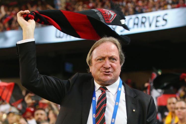 Bombers legend KEVIN SHEEDY waves his scarf during the AFL match between the Essendon Bombers and the Hawthorn Hawks at MCG in Melbourne, Australia.