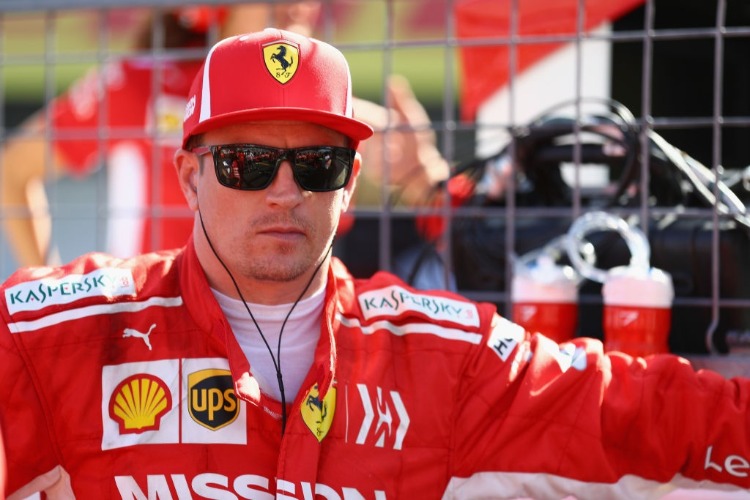 KIMI RAIKKONEN of Finland and Ferrari prepares to drive on the grid before the Formula One Grand Prix of Japan at Suzuka Circuit in Suzuka. KIMI RAIKKONEN of Finland and Ferrari prepares to drive on the grid before the Formula One Grand Prix of Japan at Suzuka Circuit in Suzuka.