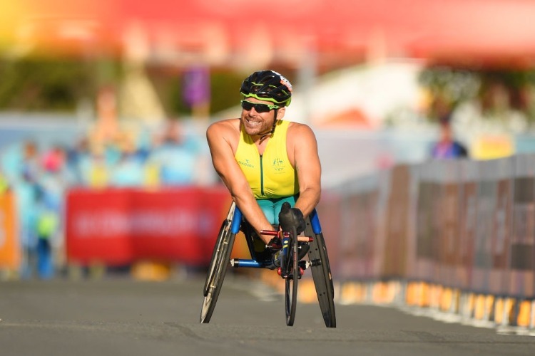 KURT FEARNLEY of Australia celebrates as he races to the line to win gold in the Men's T54 marathon of the Gold Coast 2018 Commonwealth Games at Southport Broadwater Parklands in the Gold Coast, Australia.