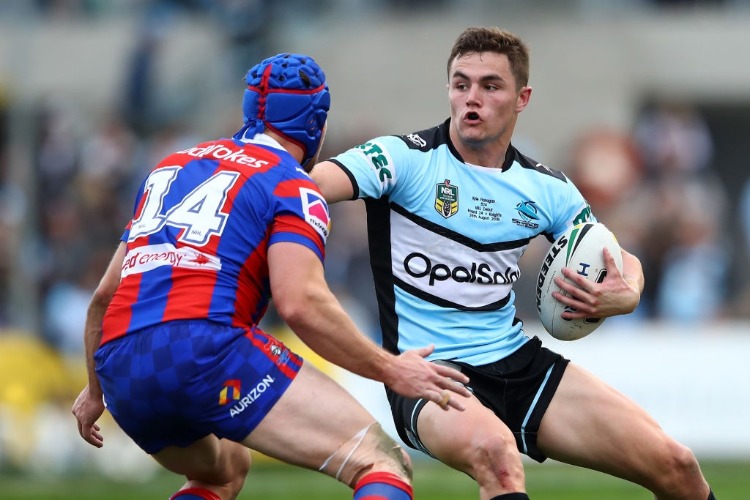 KYLE FLANAGAN of the Sharks is tackled during the NRL match between the Cronulla Sharks and the Newcastle Knights at SCG Stadium in Sydney, Australia.