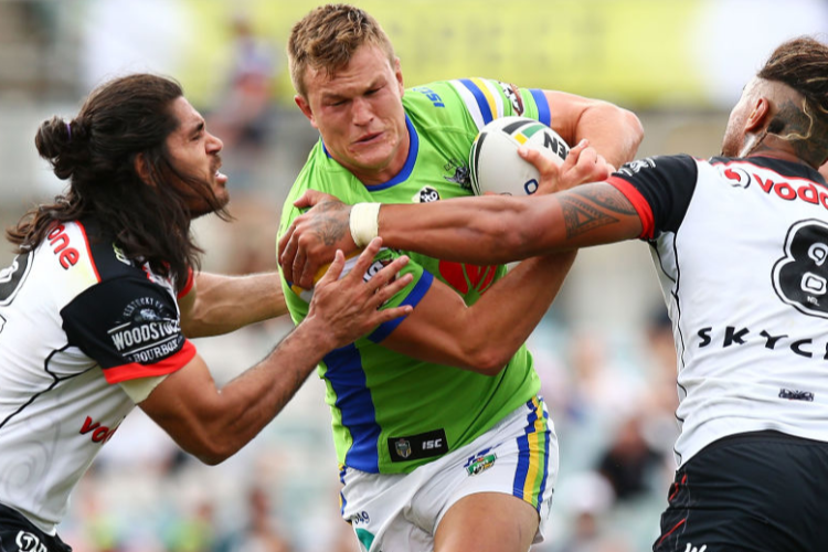 LIAM KNIGHT of the Raiders is tackled during the NRL match between the Canberra Raiders and the New Zealand Warriors at GIO Stadium in Canberra, Australia.