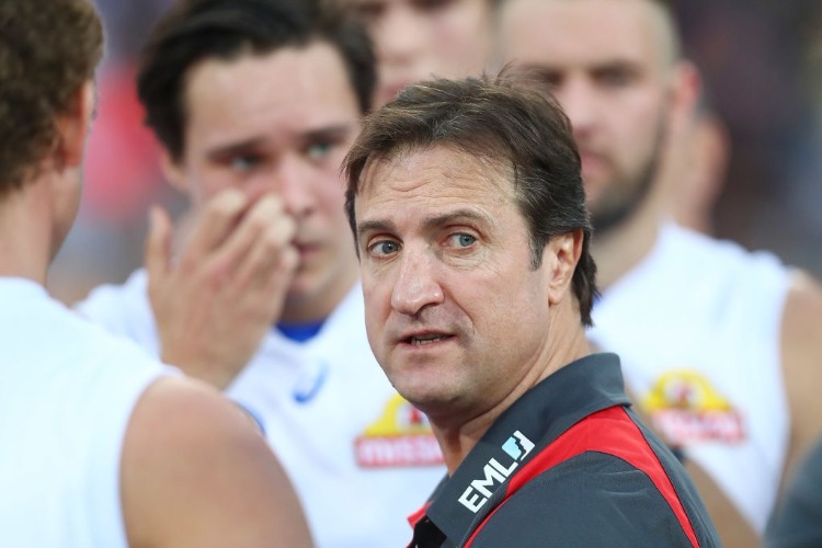 Bulldogs coach LUKE BEVERIDGE talk to players during the AFL match between the Brisbane Lions and the Western Bulldogs at The Gabba in Brisbane, Australia.