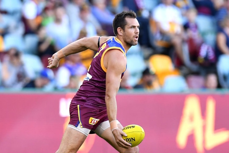 LUKE HODGE of the Lions handballs during the warmp-ups before the AFL match between the Brisbane Lions and the Hawthorn Hawks at The Gabba in Brisbane, Australia. LUKE HODGE of the Lions handballs during the warmp-ups before the AFL match between the Brisbane Lions and the Hawthorn Hawks at The Gabba in Brisbane, Australia.