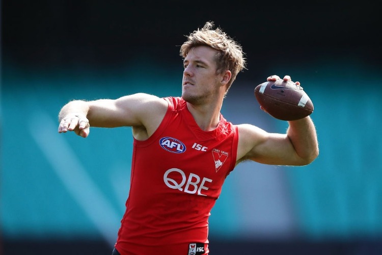 LUKE PARKER of the Swans throws an American football during a Sydney Swans AFL training session at SCG in Sydney, Australia.