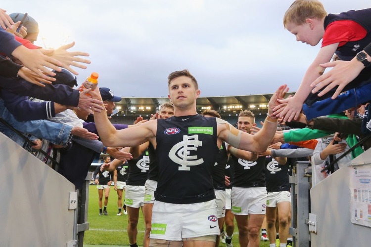 MARC MURPHY of the Blues celebrates the win with fans during the AFL match between the Collingwood Magpies and the Carlton Blues at MCG in Melbourne, Australia.