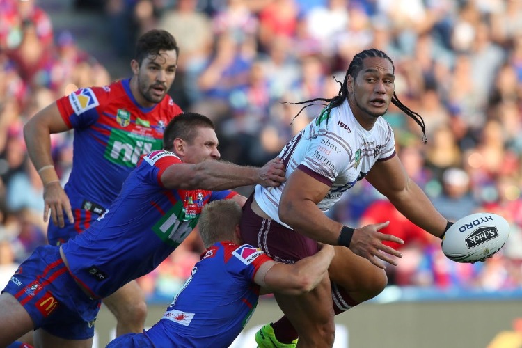 MARTIN TAUPAU of the Sea Eagles is tackled during the NRL match between the Newcastle Knights and the Manly Sea Eagles at McDonald Jones Stadium in Newcastle, Australia.