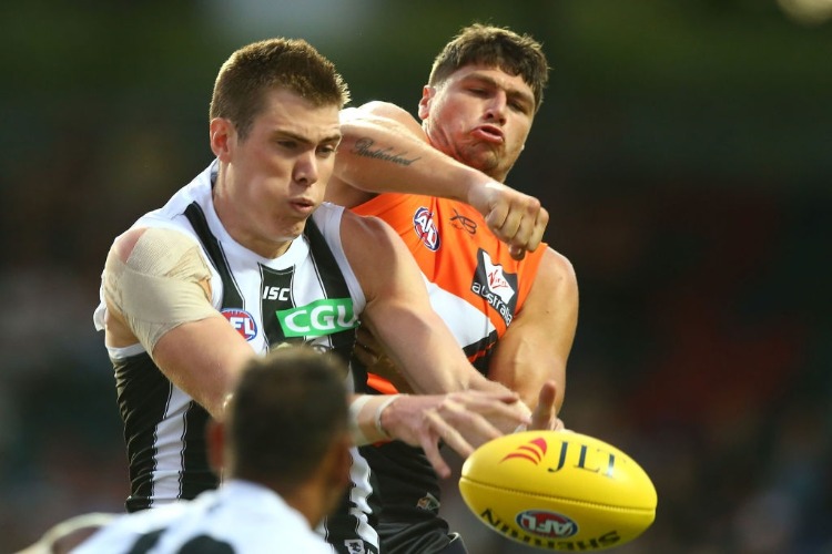 MASON COX of the Magpies and Jonathan Patton of the Giants contest possession during the JLT Community Series AFL match between the Greater Western Sydney Giants and the Collingwood Magpies at UNSW Canberra Oval in Canberra, Australia.