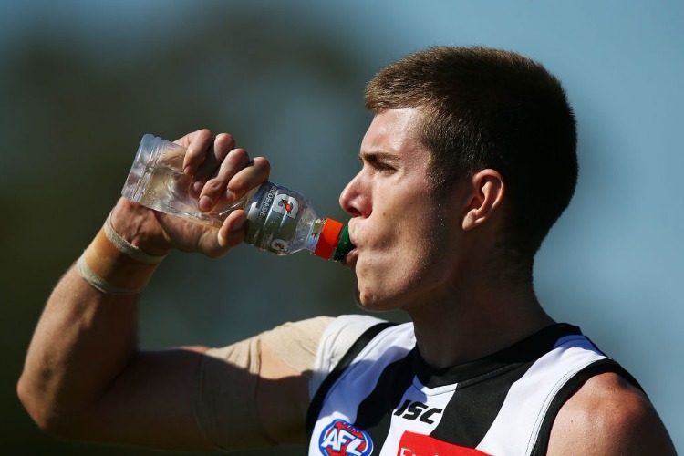 MASON COX of the Magpies hydrates with a drink during the JLT Community Series AFL match between Collingwood Magpies and the Western Bulldogs at Ted Summerton Recreational Reserve in Moe, Australia.