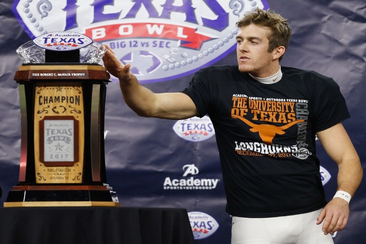 MICHAEL DICKSON #13 of the Texas Longhorns accepts the MVP award for the Academy Sports & Outdoors Bowl at NRG Stadium in Houston, Texas.