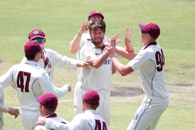 MICHAEL NESER of Queensland is congratulated by his teammates after dismissing Marcus Harris of Victoria during the Sheffield Shield match between Victoria and Queensland at MCG in Melbourne, Australia.