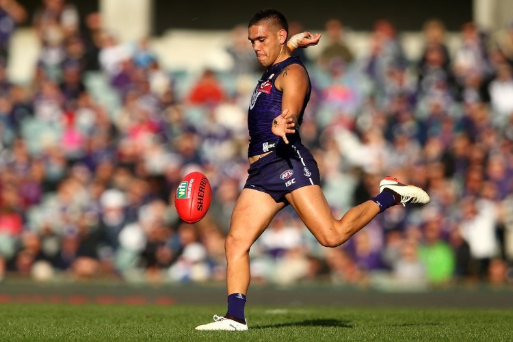 MICHAEL WALTERS of the Dockers kicks the ball into the forward line during the AFL match between the Fremantle Dockers and the St Kilda Saints at Domain Stadium in Perth, Australia.