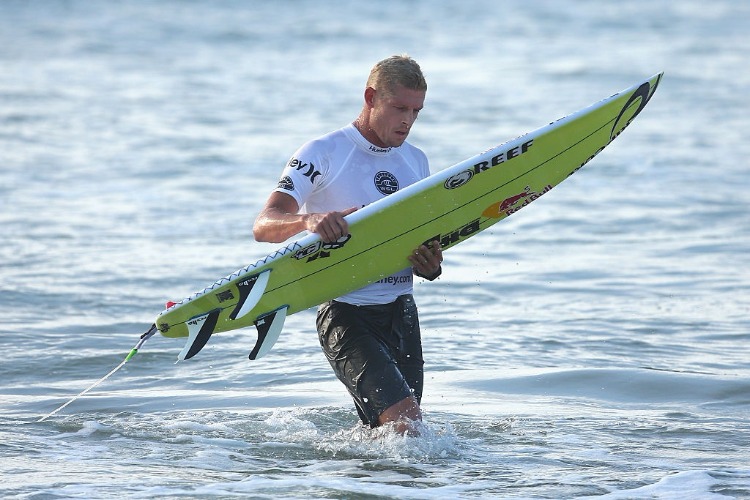 MICK FANNING of Australia returns to shore following his heat during the Australian Open of Surfing at Manly Beach in Sydney, Australia. MICK FANNING of Australia returns to shore following his heat during the Australian Open of Surfing at Manly Beach in Sydney, Australia.