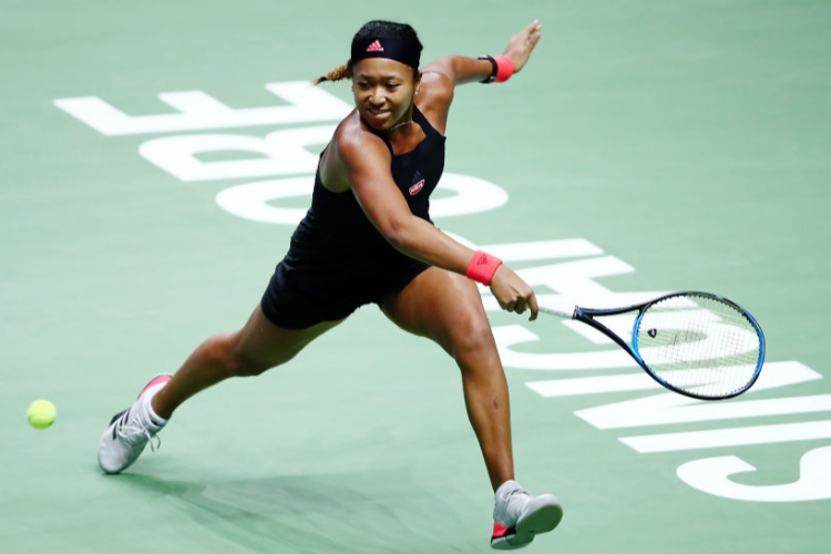 NAOMI OSAKA of Japan plays a backhand in her women's singles match against Angelique Kerber of Germany during the BNP Paribas WTA Finals Singapore presented by SC Global at Singapore Sports Hub in Singapore.