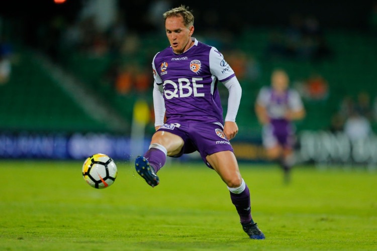 NEIL KILKENNY of the Perth Glory kicks the ball into the square during the A-League match between the Perth Glory and the Brisbane Roar at nib Stadium in Perth, Australia.