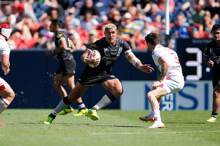 NELSON ASOFA-SOLOMONA of New Zealand runs the ball as John Bateman of England looks to make the tackle during a Rugby League Test Match between England and the New Zealand Kiwis at Sports Authority Field at Mile High in Denver, Colorado.