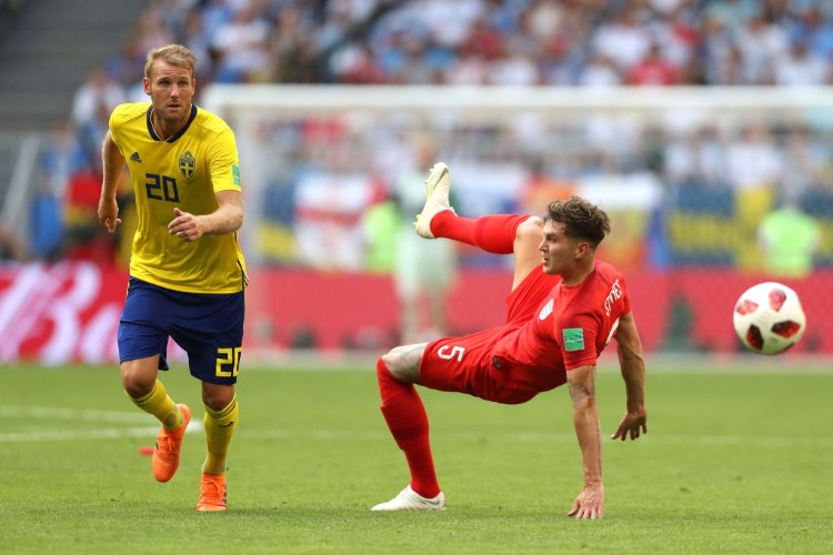 OLA TOIVONEN of Sweden and John Stones of England compete for the ball between Sweden and England in Samara, Russia.