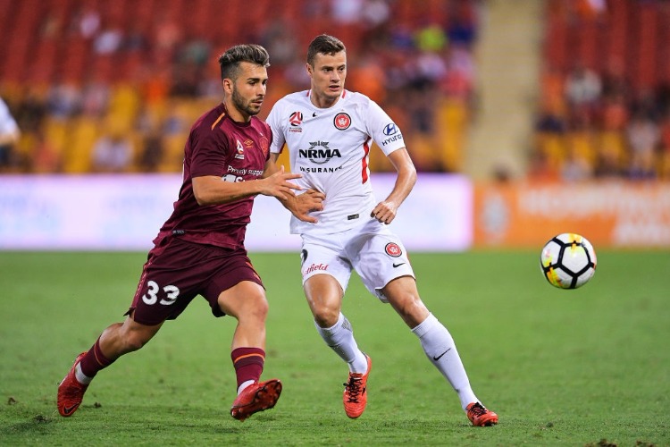 ORIOL RIERA of the Wanderers and PETROS SKAPETIS of Brisbane contest the ball during the A-League match between the Brisbane Roar and the Western Sydney Wanderers at Suncorp Stadium in Brisbane, Australia.