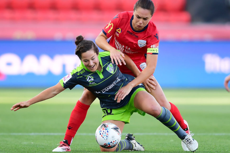 PAIGE NIELSEN of Canberra United competes for the ball against EMMA CHECKER of Adelaide United during the W-League match between Adelaide United and Canberra United at CS in Adelaide, Australia.