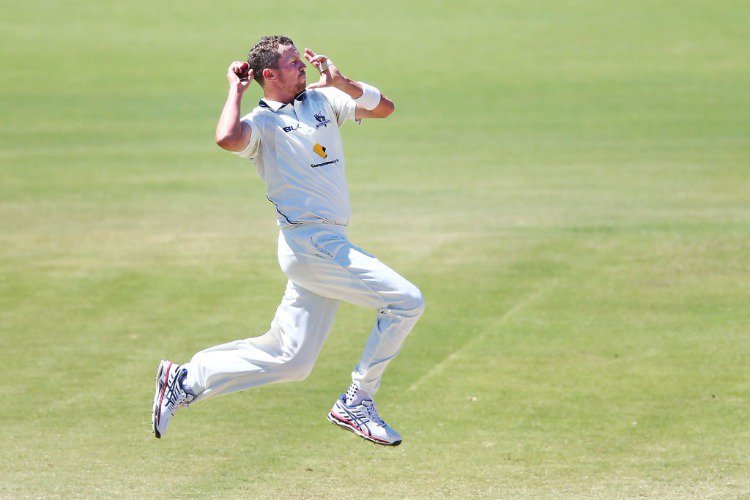 PETER SIDDLE of Victoria bowls during the Sheffield Shield match between Victoria and New South Wales at Junction Oval in Melbourne, Australia.