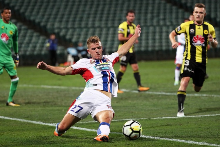 RILEY MCGREE of the Newcastle Jets slides for the ball during the A-League match between the Wellington Phoenix and the Newcastle Jets at QBE Stadium in Auckland, New Zealand.
