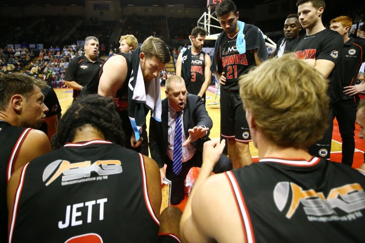 Hawks coach ROB BEVERIDGE talks to his players during a break during the NBL match between the Illawarra Hawks and Melbourne United in Wollongong, Australia. Hawks coach ROB BEVERIDGE talks to his players during a break during the NBL match between the Illawarra Hawks and Melbourne United in Wollongong, Australia.