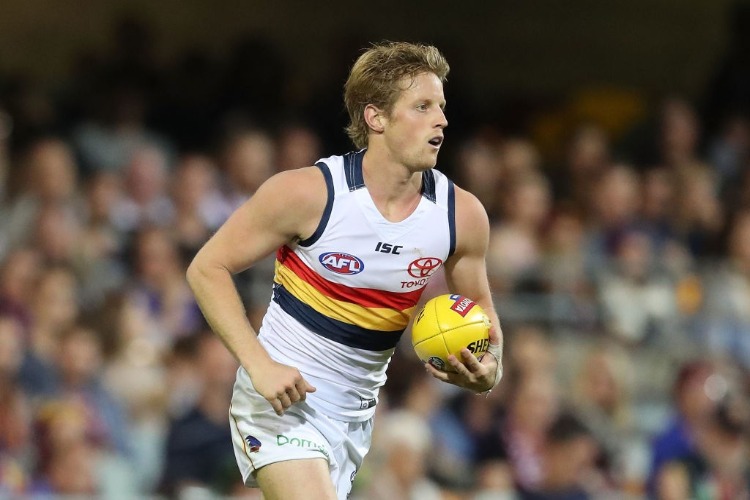 RORY SLOANE of the Crows runs with the ball during the AFL match between the Brisbane Lions and the Adelaide Crows at The Gabba in Brisbane, Australia.