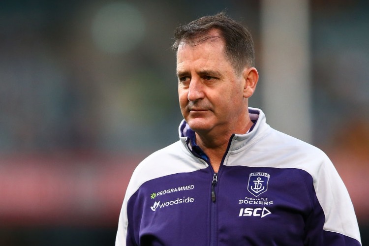 Dockers head coach ROSS LYON looks on while players warm up during the AFL match between the Fremantle Dockers and the Hawthorn Hawks at Domain Stadium in Perth, Australia.