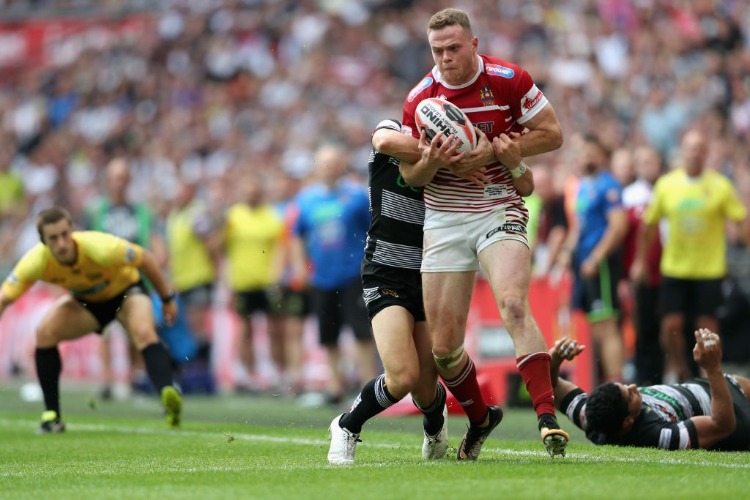 RYAN SUTTON is tackled during Hull FC v Wigan Warriors in the Ladbrokes Challenge Cup at Wembley Stadium in London