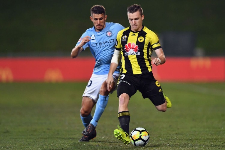 SCOTT GALLOWAY of the Phoenix controls the ball from Dario Vidosic of Melbourne City during the A-League match between the Wellington Phoenix and Melbourne City FC at QBE Stadium in Auckland, New Zealand.