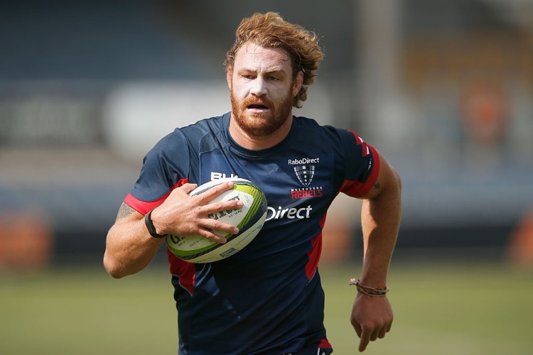 SCOTT HIGGINBOTHAM runs with the ball during a Melbourne Rebels Super Rugby training session at Visy Park in Melbourne, Australia.