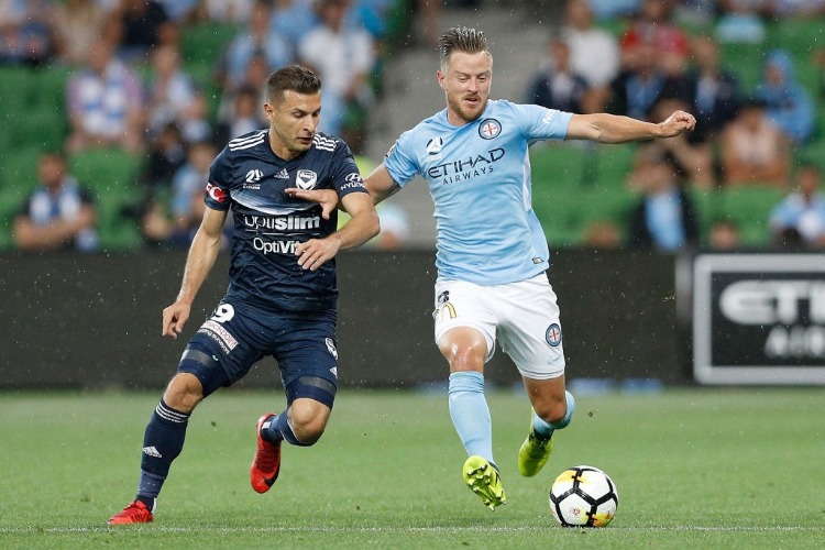 SCOTT JAMIESON of Melbourne City and Kosta Barbarouses of the Victory contest the ball during the A-League match between Melbourne City and Melbourne Victory at AAMI Park in Melbourne, Australia.