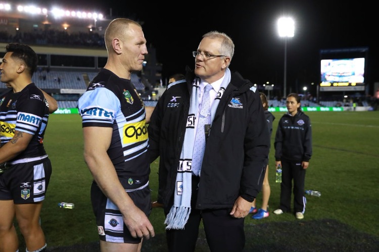 LUKE LEWIS of the Sharks celebrates after his 300th NRL match with Federal Treasurer SCOTT MORRISON.