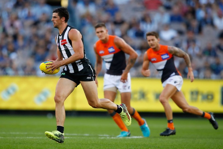 SCOTT PENDLEBURY of the Magpies runs with the ball during the AFL match between the Collingwood Magpies and the Greater Western Sydney Giants at MCG in Melbourne, Australia. SCOTT PENDLEBURY of the Magpies runs with the ball during the AFL match between the Collingwood Magpies and the Greater Western Sydney Giants at MCG in Melbourne, Australia.