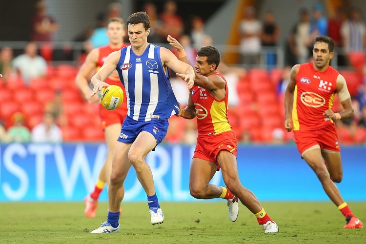 SCOTT THOMPSON of the Kangaroos kicks during the AFL match between the Gold Coast Suns and the North Melbourne Kangaroos at Metricon Stadium in Gold Coast, Australia.