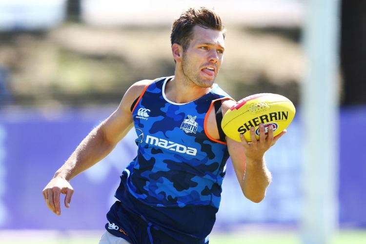 SHAUN HIGGINS of the Kangaroos runs with the ball during a North Melbourne Kangaroos AFL training session at Arden Street Ground in Melbourne, Australia.