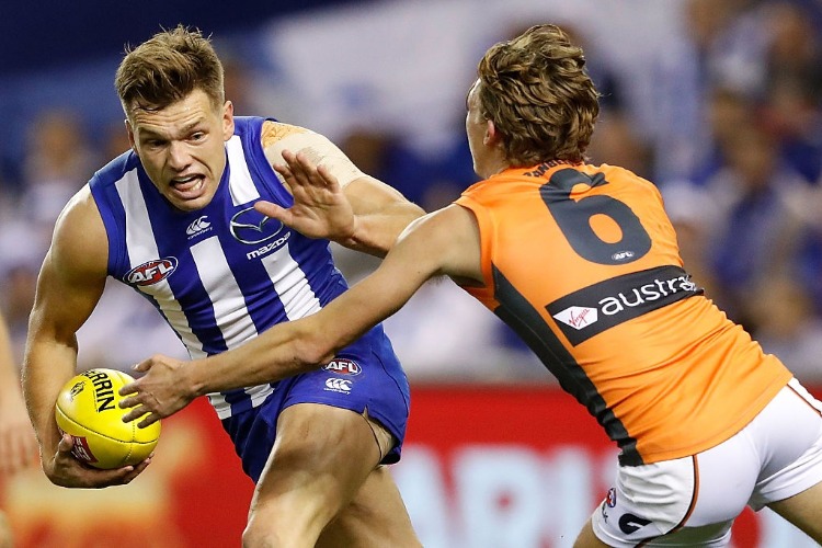 SHAUN HIGGINS of the Kangaroos is tackled by Lachie Whitfield of the Giants during the 2016 AFL match between the North Melbourne Kangaroos and the GWS Giants at Etihad Stadium in Melbourne, Australia.