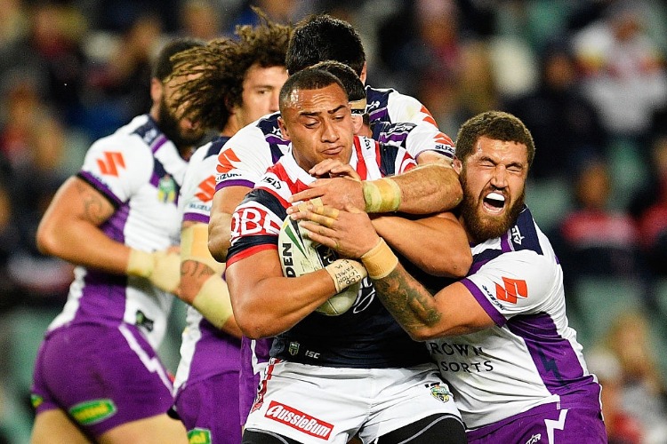 SIO SIUA TAUKEIAHO of the Roosters is tackled during the NRL match between the Sydney Roosters and the Melbourne Storm at Allianz Stadium in Sydney, Australia.