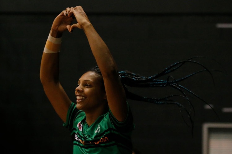 STACEY FRANCIS of the West Coast Fever shows the love as she runs out onto the court before the Super Netball match between the Fever and the Swifts at HBF Stadium in Perth, Australia.