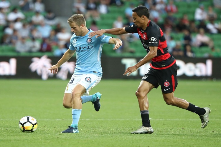 STEFAN MAUK of the City is challenged by KEARYN BACCUS of the Wanderers during the A-League match between Melbourne City and the Western Sydney Wanderers at AAMI Park in Melbourne, Australia.