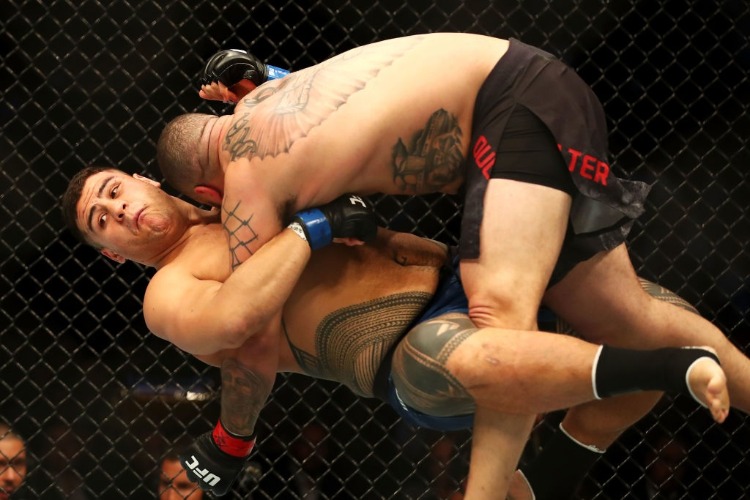 TAI TUIVASA of Australia takes down Rashad Coulter of the USA in their heavyweight bout during the UFC Fight Night at Qudos Bank Arena in Sydney, Australia.