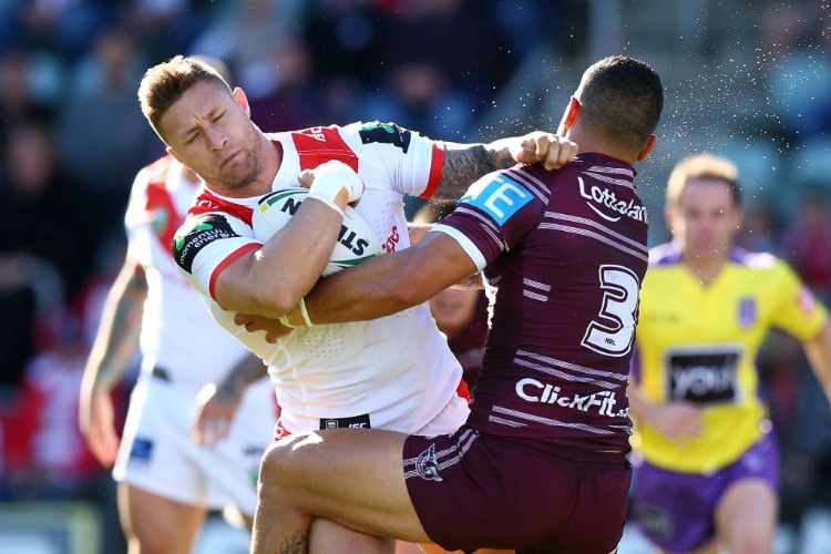 TARIQ SIMS of the Dragons is tackled by DYLAN WALKER of the Eagles during the NRL match between the St George Illawarra Dragons and the Manly Sea Eagles at WIN Stadium in Wollongong, Australia.