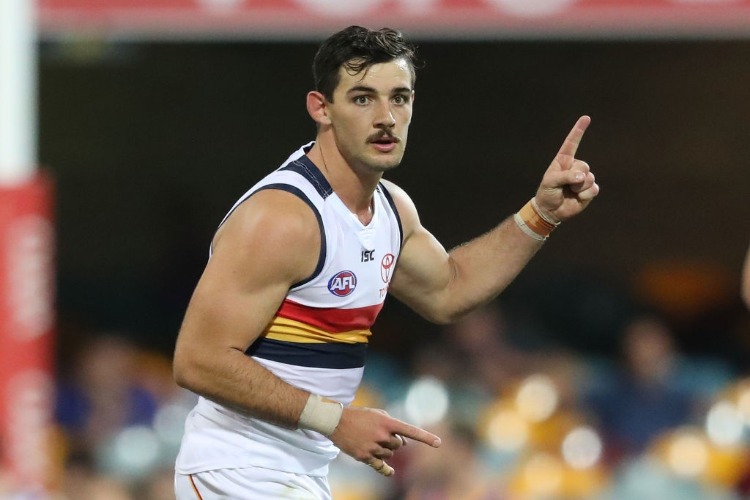 TAYLOR WALKER of the Crows celebrates after kicking a goal during the AFL match between the Brisbane Lions and the Adelaide Crows at The Gabba in Brisbane, Australia.