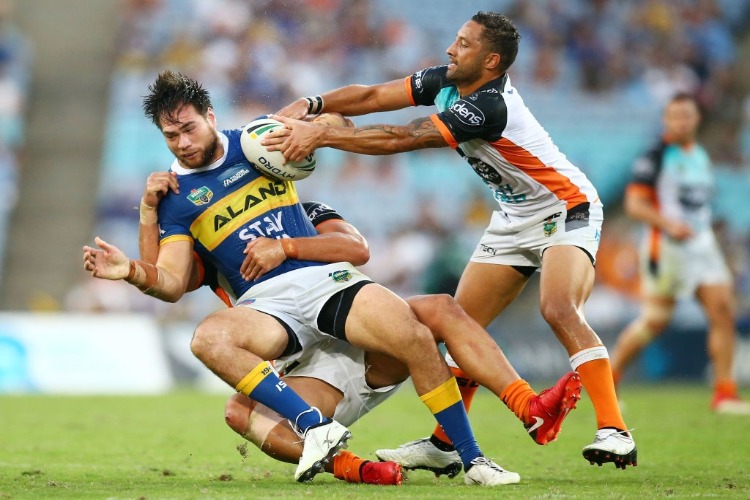 TEPAI MOEROA of the Eels is tackled during the NRL match between the Wests Tigers and the Parramatta Eels at ANZ Stadium in Sydney, Australia.