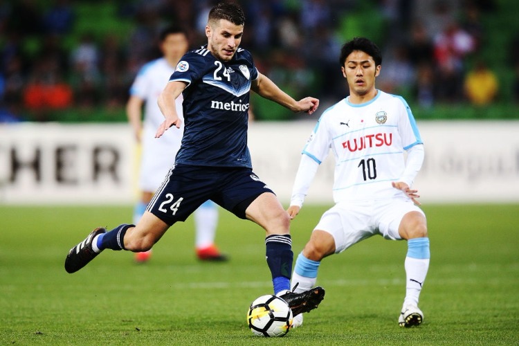 TERRY ANTONIS of the Victory kicks the ball clear from RYOTA OSHIMA of Kawasaki Frontale during the AFC Asian Champions League match between the Melbourne Victory and Kawasaki Frontale at AAMI Park in Melbourne, Australia.