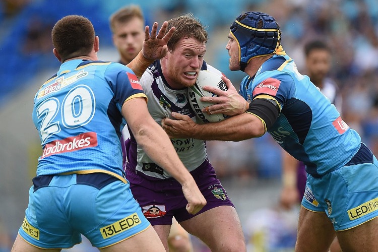 TIM GLASBY of the Storm is tackled during the NRL match between the Gold Coast Titans and the Melbourne Storm in Gold Coast, Australia. TIM GLASBY of the Storm is tackled during the NRL match between the Gold Coast Titans and the Melbourne Storm in Gold Coast, Australia.