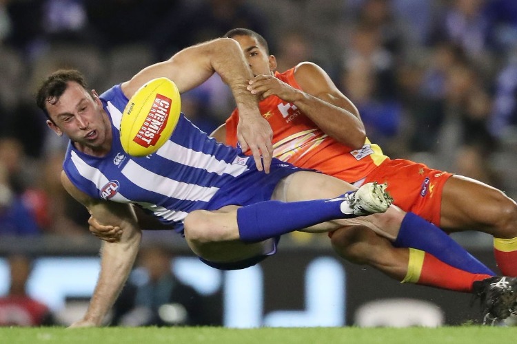 TODD GOLDSTEIN of the Kangaroos is tackled during the AFL match between the North Melbourne Kangaroos and the Gold Coast Suns at Etihad Stadium in Melbourne, Australia.