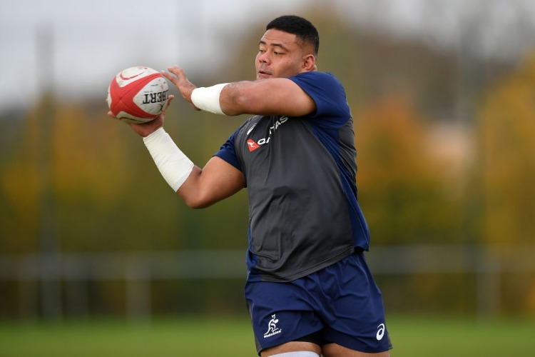 TOLU LATU of Australia receives a pass during a training session in Newport, Wales.