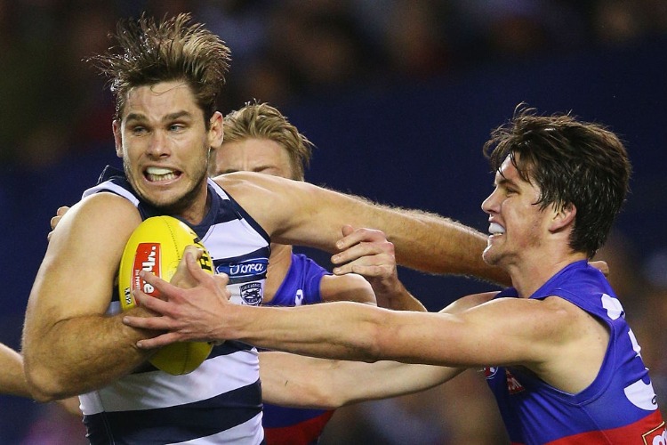 TOM HAWKINS of the Cats is tackled by Jordan Kelly of the Bulldogs (R) during the AFL match between the Western Bulldogs and the Geelong Cats at Etihad Stadium in Melbourne, Australia.