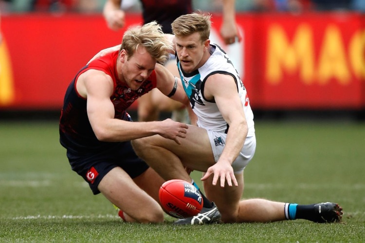 Jack Watts of the Demons and TOM JONAS of the Power compete for the ball during the AFL match between the Melbourne Demons and the Port Adelaide Power at the MCG in Melbourne, Australia.